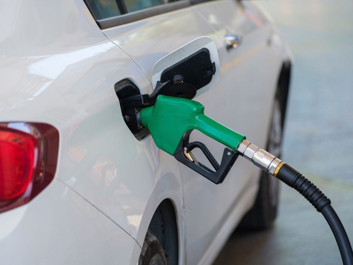 Bomba de combustível verde abastecendo um veículo em posto de gasolina